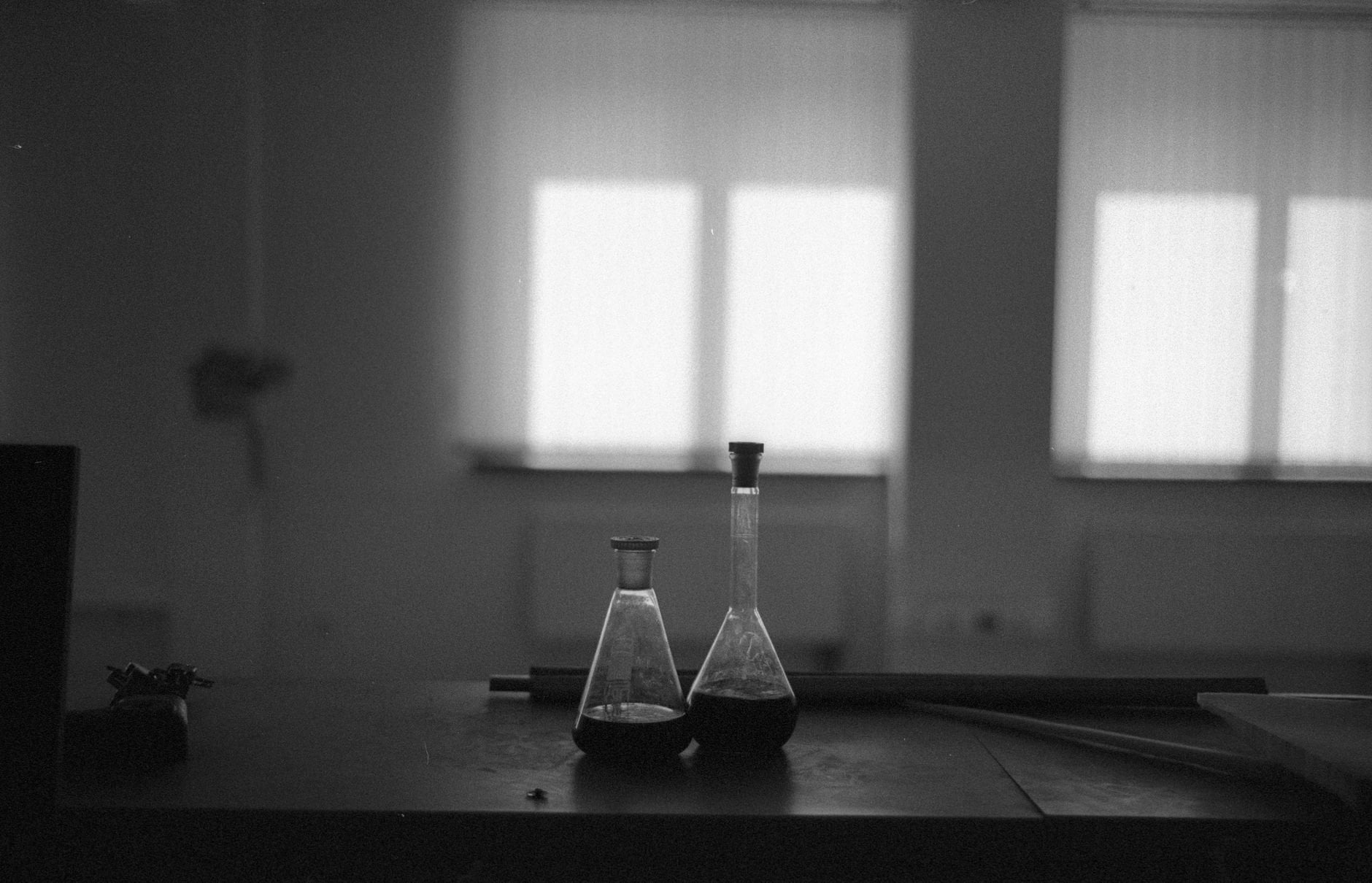 Laboratory vials on a dark table — science in the dark